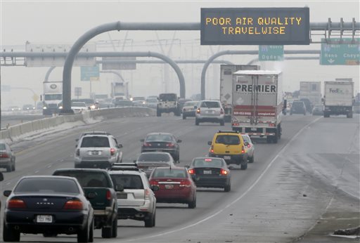 FILE - This Jan. 23, 2013, file photo, shows a poor air quality sign is posted over a highway, in Salt Lake City.  A watchdog group believes regulators could lean more heavily on industry to cut emissions in urban areas of northern Utah. The Healthy Environment Alliance of Utah is scrutinizing a plan to fight air pollution that regulators are shopping for public comment. The plan requires wider use of off-the-shelf technology to control industrial emissions, but stops at requiring the most advanced controls.  (AP Photo/Rick Bowmer, File)